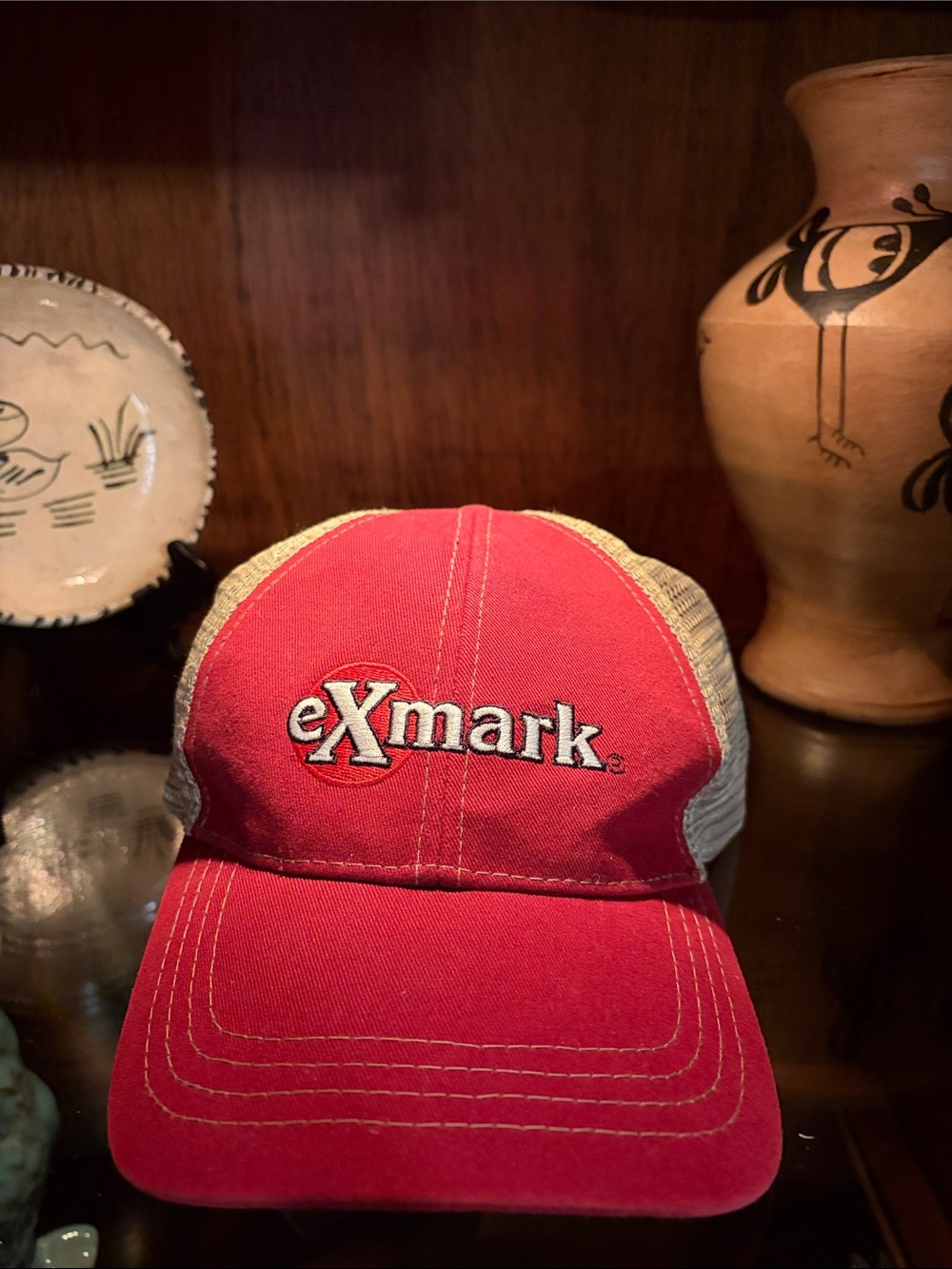 Red and beige Trucker Hat with eXmark Logo